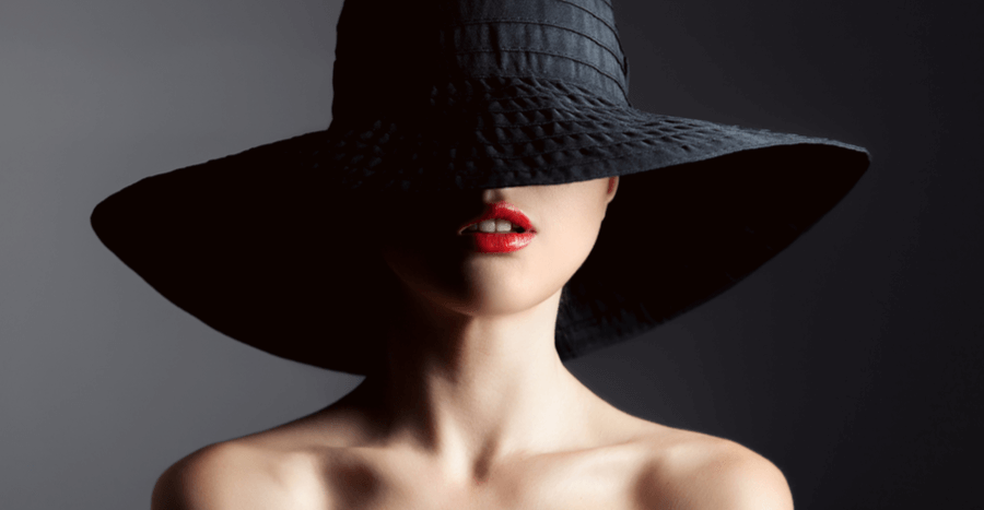 Woman with red lips wearing wide brim black hat