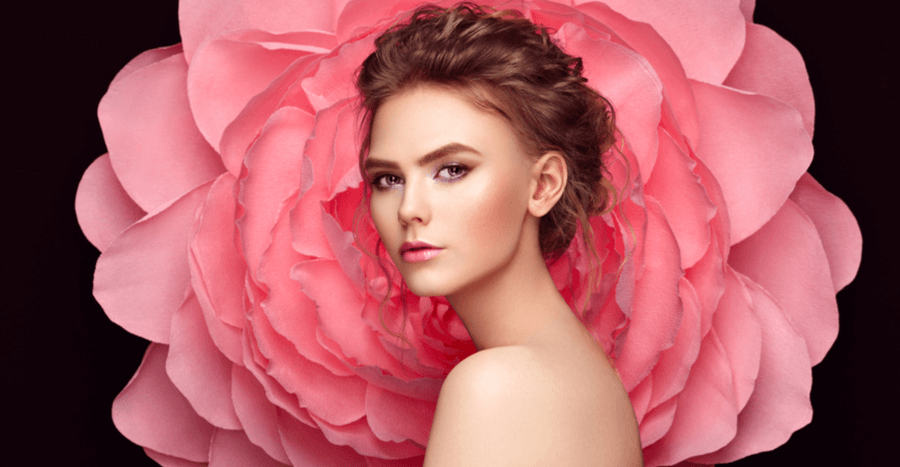 Portrait of a beautiful female with big pink flower as the background